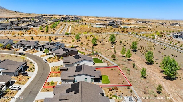 drone / aerial view with a desert view and a residential view