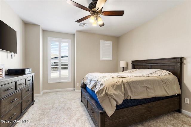 bedroom featuring baseboards, visible vents, a ceiling fan, and light colored carpet