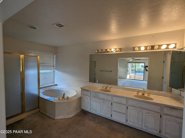 full bath featuring a garden tub, a sink, double vanity, and a shower stall