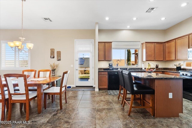 kitchen featuring gas stove, visible vents, a kitchen island, an inviting chandelier, and dishwasher