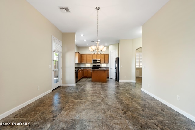 6380 E Deacon St, Prescott Valley, AZ 86314 - kitchen featuring appliances with stainless steel finishes, a chandelier, dark countertops, open floor plan, and plenty of natural light