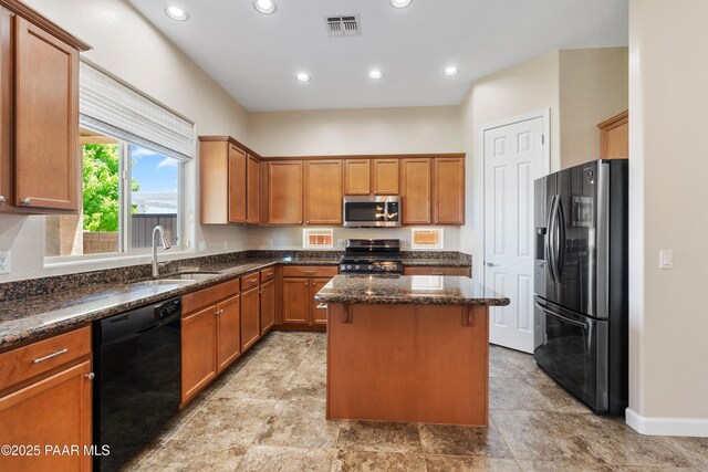 6380 E Deacon St, Prescott Valley, AZ 86314 - kitchen featuring stainless steel appliances, a sink, a kitchen island, dark stone countertops, and brown cabinets