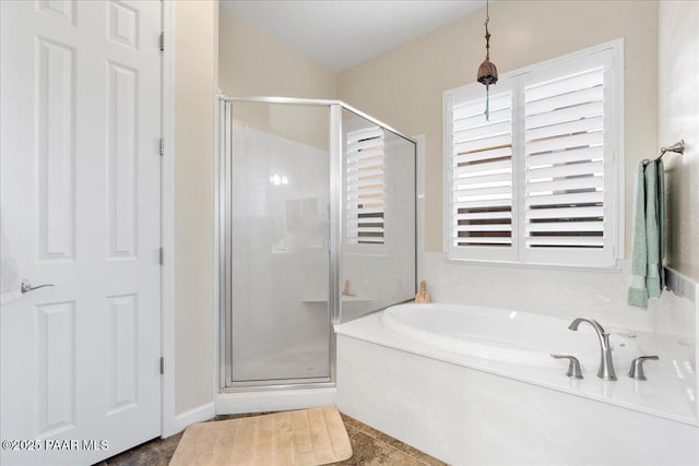 full bath featuring a shower stall and a garden tub