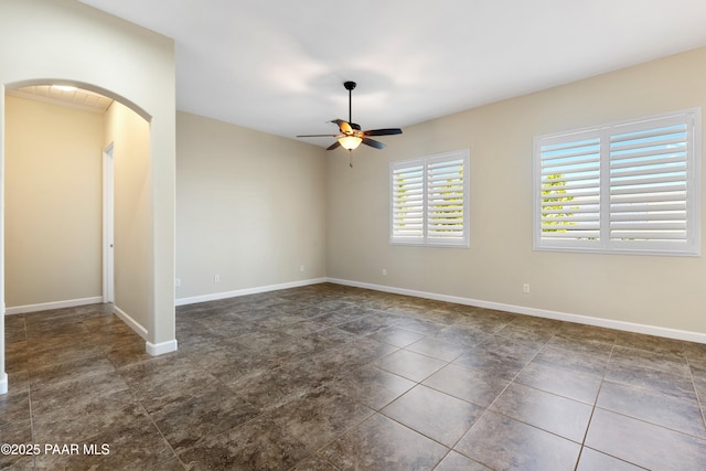 6380 E Deacon St, Prescott Valley, AZ 86314 - spare room featuring arched walkways, a ceiling fan, and baseboards