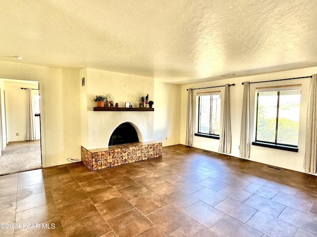 unfurnished living room featuring a textured ceiling