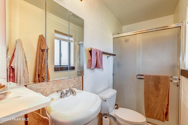 bathroom with toilet, an enclosed shower, and sink