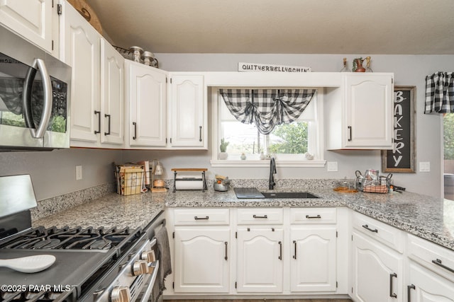 11755 Hondo Hts, Dewey-Humboldt, AZ 86327 - kitchen featuring stainless steel appliances, a sink, white cabinets, and light stone counters