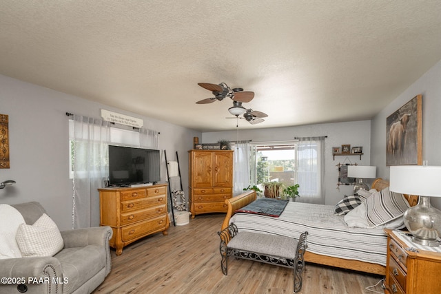 11755 Hondo Hts, Dewey-Humboldt, AZ 86327 - bedroom featuring light wood-style flooring, a textured ceiling, and ceiling fan