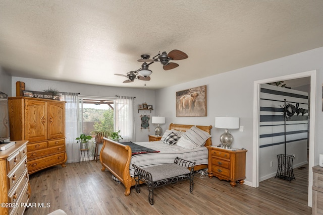 11755 Hondo Hts, Dewey-Humboldt, AZ 86327 - bedroom with light wood finished floors, a textured ceiling, ceiling fan, and baseboards