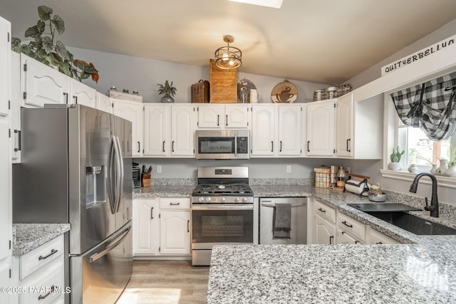 11755 Hondo Hts, Dewey-Humboldt, AZ 86327 - kitchen with stainless steel appliances, a sink, white cabinets, light stone countertops, and lofted ceiling