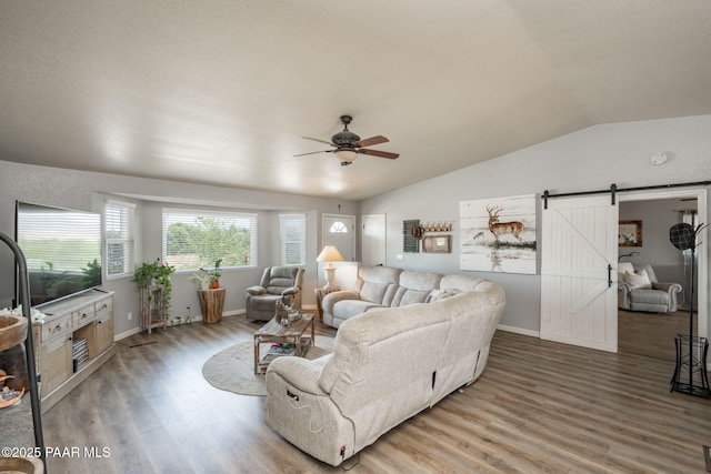 11755 Hondo Hts, Dewey-Humboldt, AZ 86327 - living room featuring a barn door, wood finished floors, ceiling fan, lofted ceiling, and baseboards