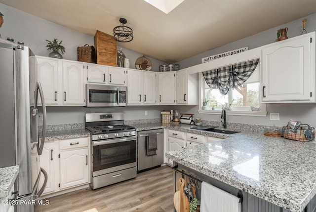 11755 Hondo Hts, Dewey-Humboldt, AZ 86327 - kitchen featuring stainless steel appliances, lofted ceiling, white cabinetry, light wood-type flooring, and light stone counters