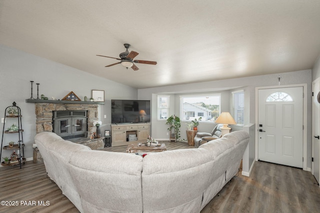 11755 Hondo Hts, Dewey-Humboldt, AZ 86327 - living area featuring a stone fireplace, wood finished floors, vaulted ceiling, a ceiling fan, and baseboards