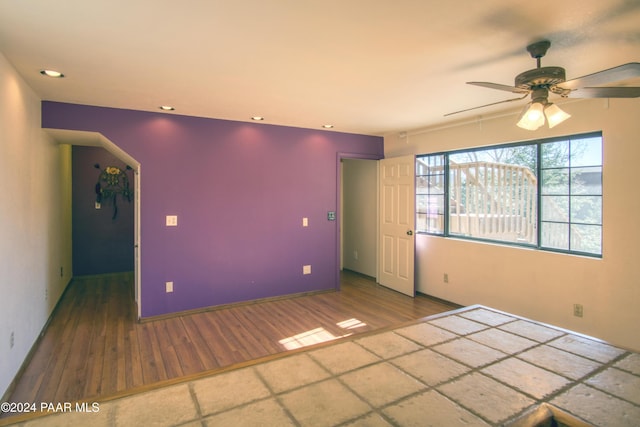 empty room featuring hardwood / wood-style floors and ceiling fan