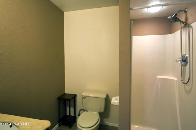 bathroom with toilet and walk in shower