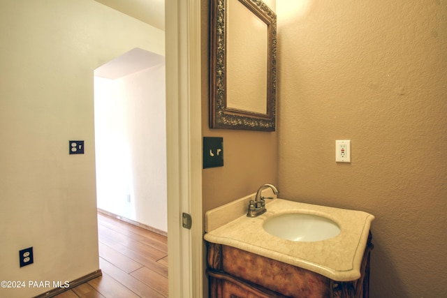 bathroom with vanity and wood-type flooring