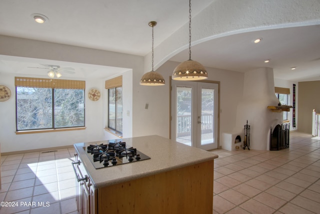 kitchen featuring black gas cooktop, hanging light fixtures, ceiling fan, and a healthy amount of sunlight