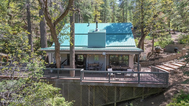 rear view of property with a wooden deck