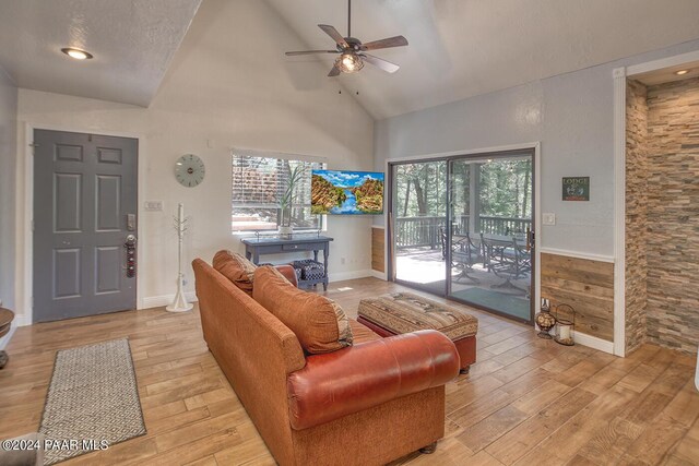 living room featuring ceiling fan, plenty of natural light, high vaulted ceiling, and light hardwood / wood-style floors