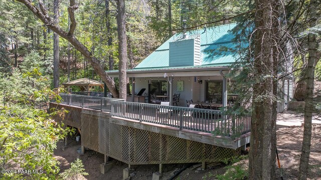 rear view of property featuring a deck