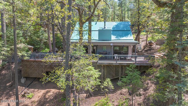 rear view of house featuring a wooden deck