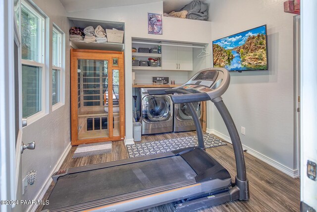 workout area with hardwood / wood-style floors and washing machine and clothes dryer