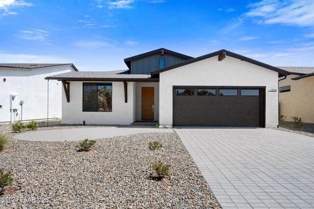 1324 Rockwood Dr, Prescott, AZ 86305 - view of front of home with an attached garage, stucco siding, and decorative driveway