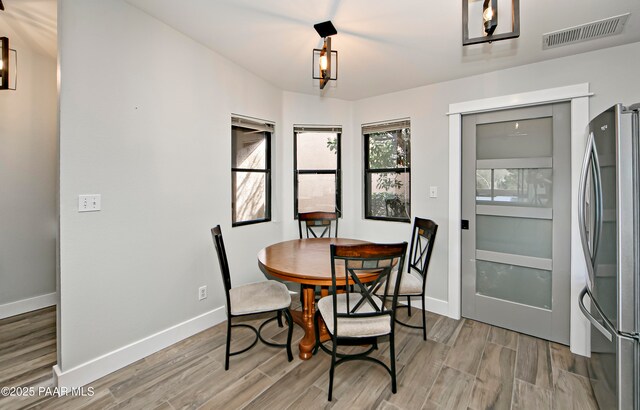 2151 S Resort Way Unit 1C, Prescott, AZ 86301 - dining room with visible vents, baseboards, and light wood-style flooring