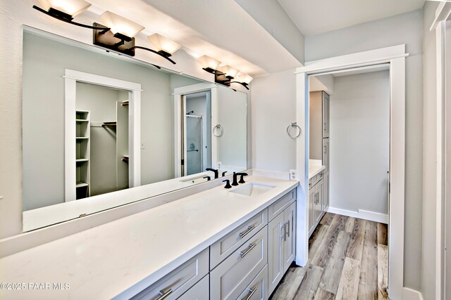 2151 S Resort Way Unit 1C, Prescott, AZ 86301 - bathroom with vanity, baseboards, an enclosed shower, a walk in closet, and wood finished floors