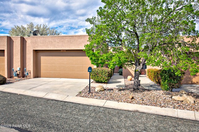 2151 S Resort Way Unit 1C, Prescott, AZ 86301 - view of front facade featuring driveway, a garage, and stucco siding