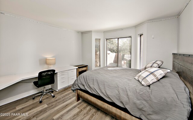 2151 S Resort Way Unit 1C, Prescott, AZ 86301 - bedroom with built in desk and light wood-style flooring