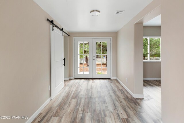 315 N Robinson Dr, Prescott, AZ 86303 - entryway featuring a barn door, wood finished floors, baseboards, and french doors
