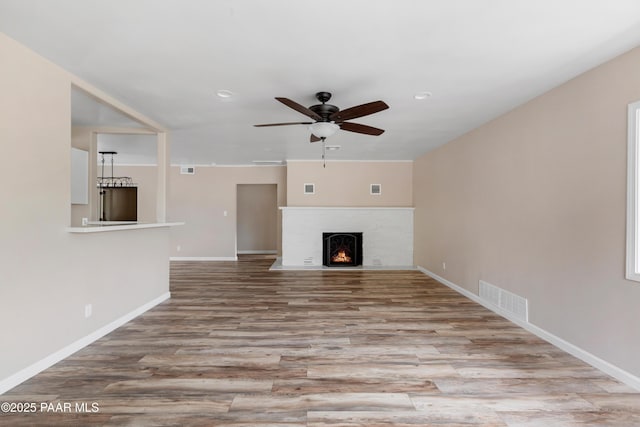 315 N Robinson Dr, Prescott, AZ 86303 - unfurnished living room with wood finished floors, a ceiling fan, baseboards, a brick fireplace, and recessed lighting