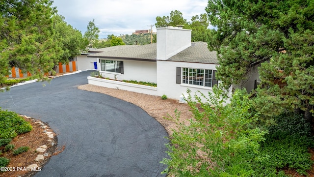 315 N Robinson Dr, Prescott, AZ 86303 - view of front of property with a shingled roof, asphalt driveway, a chimney, and stucco siding