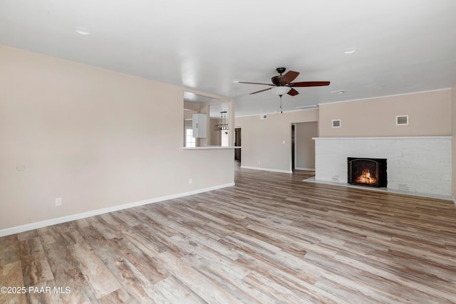 315 N Robinson Dr, Prescott, AZ 86303 - unfurnished living room with a ceiling fan, wood finished floors, a fireplace, and baseboards