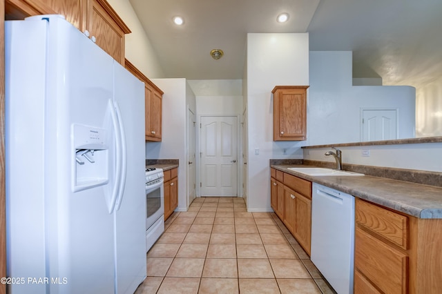 kitchen with light tile patterned floors, sink, and white appliances