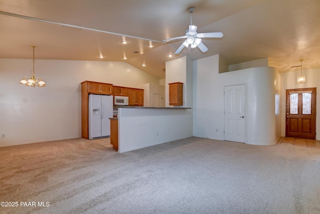 unfurnished living room with light carpet, vaulted ceiling, and ceiling fan with notable chandelier