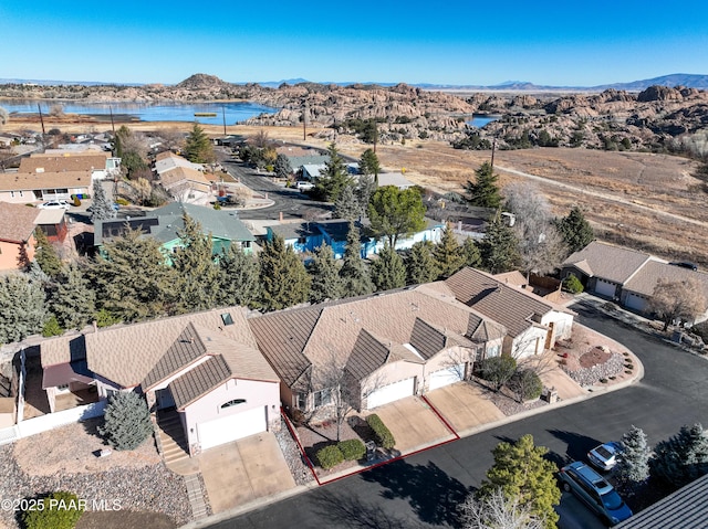 birds eye view of property with a water and mountain view