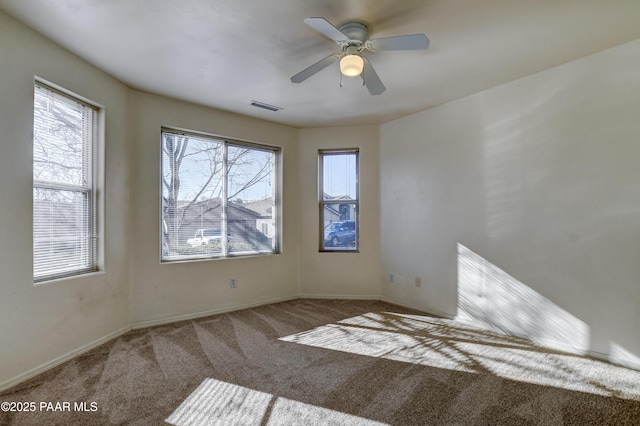 spare room with ceiling fan and carpet floors