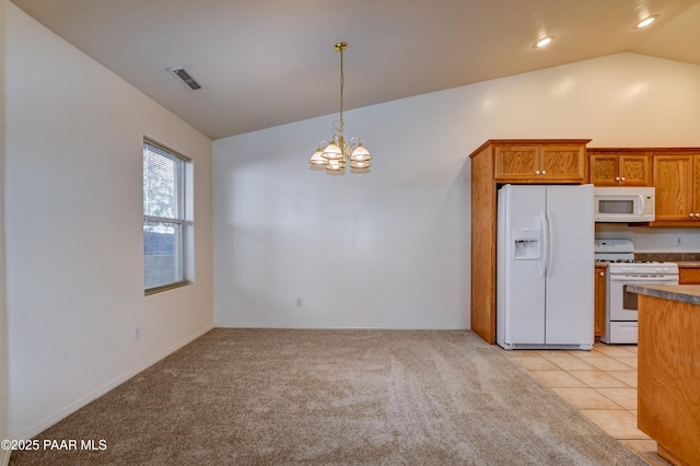 kitchen with a notable chandelier, white appliances, light tile patterned flooring, hanging light fixtures, and vaulted ceiling