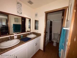 16432 Incline Trl, Williams, AZ 86046 - bathroom featuring double vanity, toilet, and wood finished floors