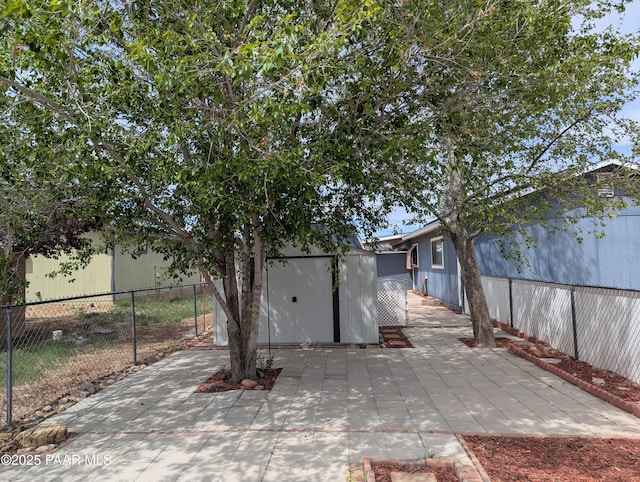 3718 N Navajo Dr, Prescott Valley, AZ 86314 - back of house with a fenced backyard, an outdoor structure, a patio area, and a storage shed