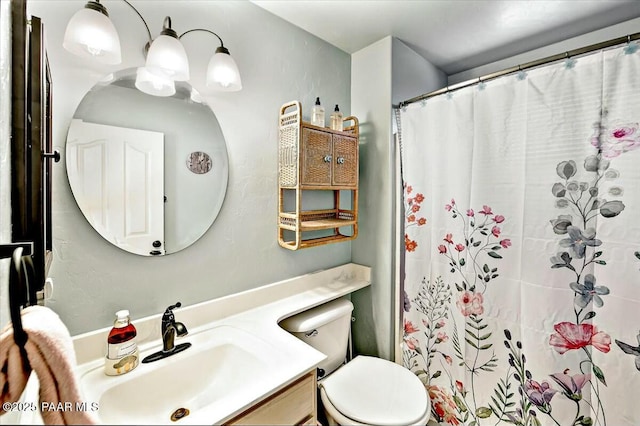 bathroom featuring a shower with curtain, vanity, and toilet