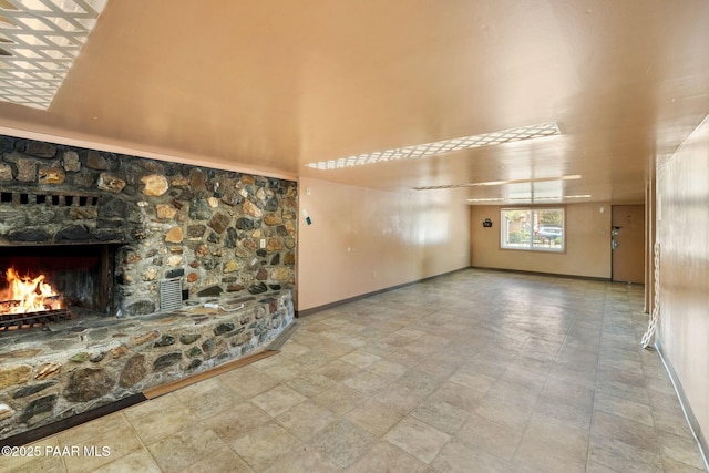 229 Creekside Cir Unit 15C, Prescott, AZ 86303 - unfurnished living room with a stone fireplace, baseboards, and a high ceiling