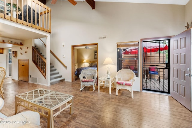 229 Creekside Cir Unit 15C, Prescott, AZ 86303 - living area featuring a ceiling fan, a high ceiling, wood finished floors, and stairs