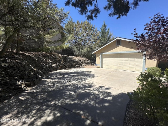 2508 N Leah Ln, Prescott, AZ 86301 - view of side of home featuring stucco siding, an attached garage, and driveway