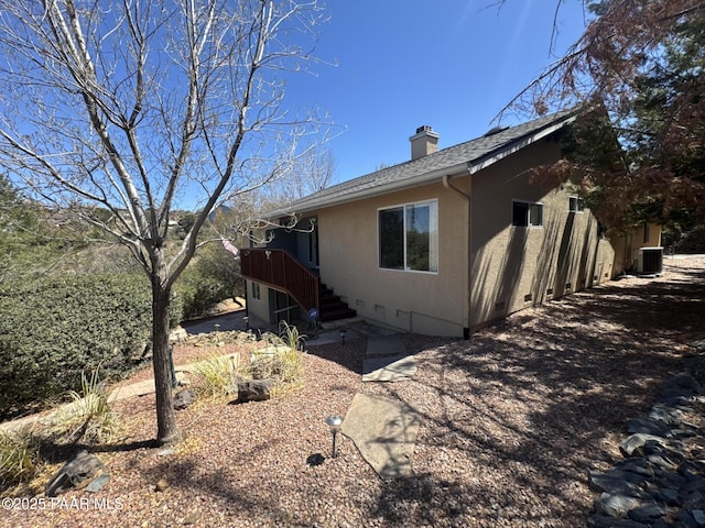 2508 N Leah Ln, Prescott, AZ 86301 - view of side of home with central air condition unit, a chimney, a shingled roof, and stucco siding