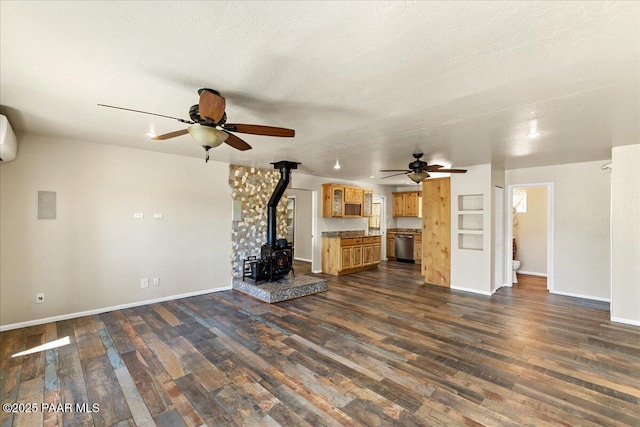 4820 S Lund Ct, Prescott, AZ 86303 - unfurnished living room with a ceiling fan, a wood stove, and dark wood finished floors