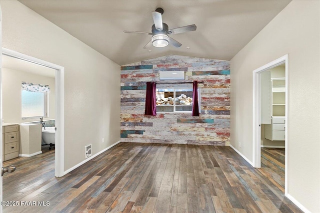 4820 S Lund Ct, Prescott, AZ 86303 - unfurnished living room featuring an accent wall, ceiling fan, lofted ceiling, wood finished floors, and a desk