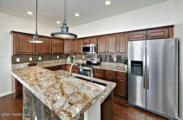 7273 Woolsey Ranch Rd, Prescott Valley, AZ 86314 - kitchen with appliances with stainless steel finishes, light stone countertops, backsplash, dark wood-style floors, and recessed lighting